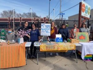 people hosting a bake sale and art fundraiser to support teachers