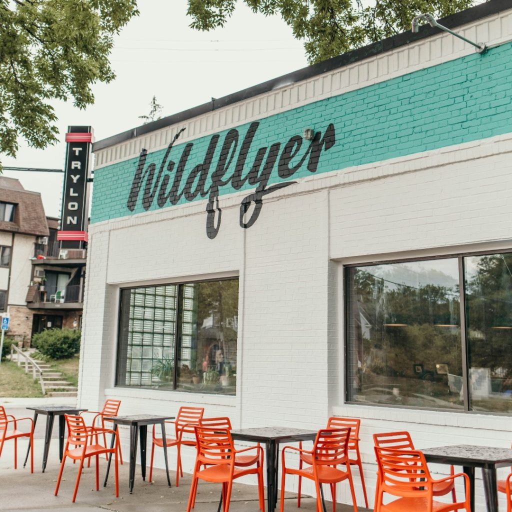 the wildflyer coffee shop with orange patio tables out front